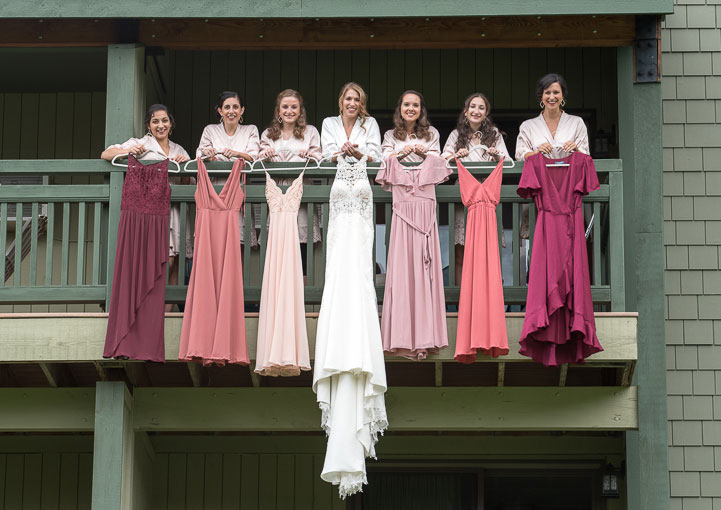 bridesmaids with dresses hanging over porch