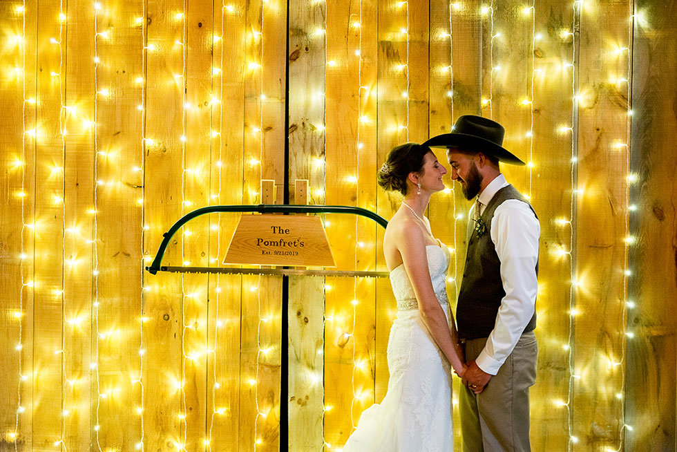couple in front of string lights