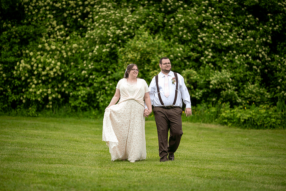 Married couple walking in field