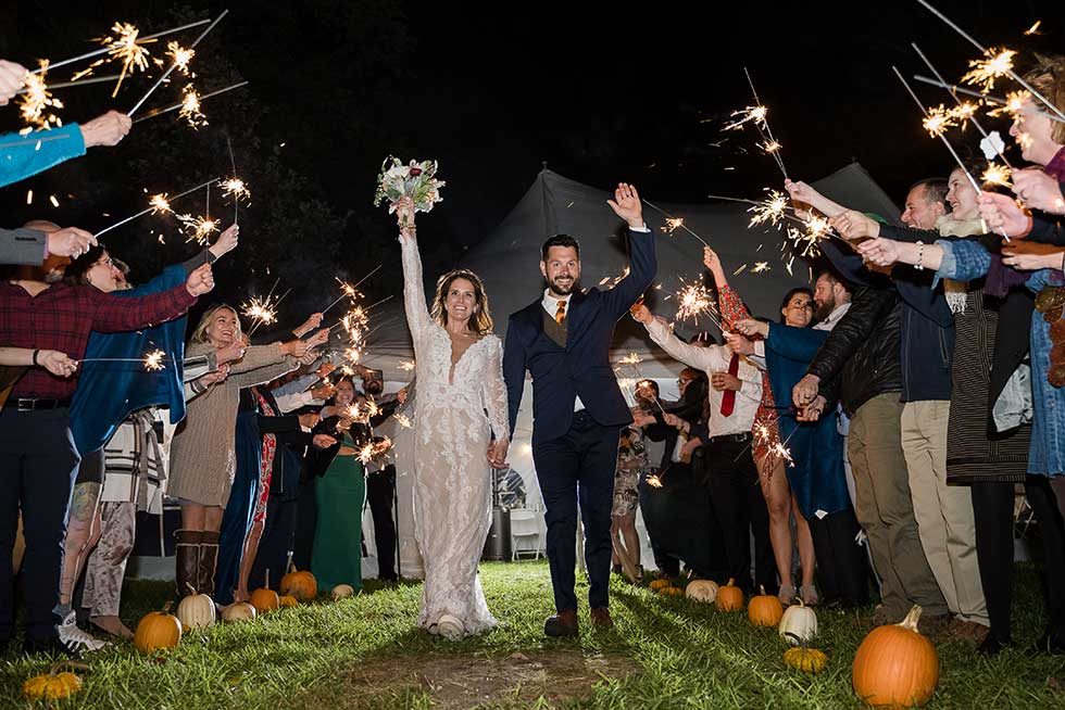 newlyweds exiting under night sparklers