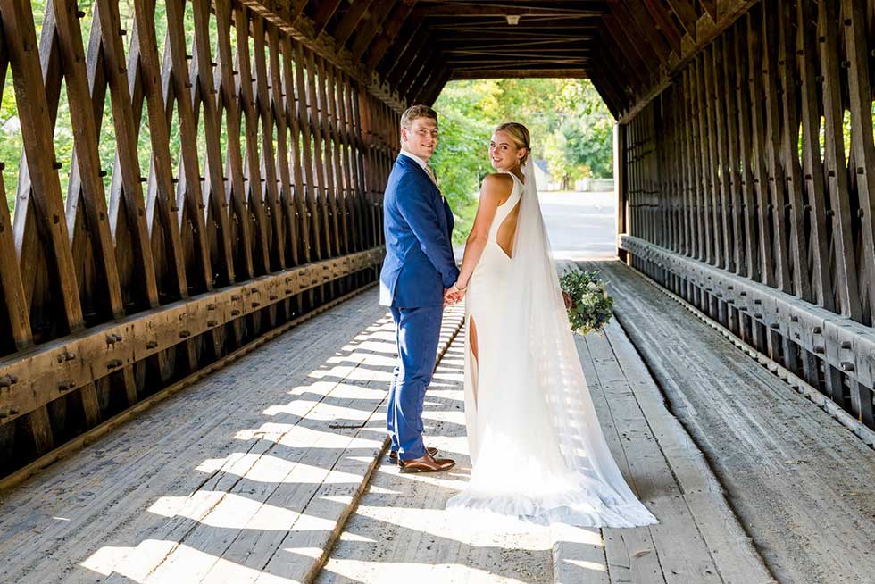 wedding photo of couple in covered bridge