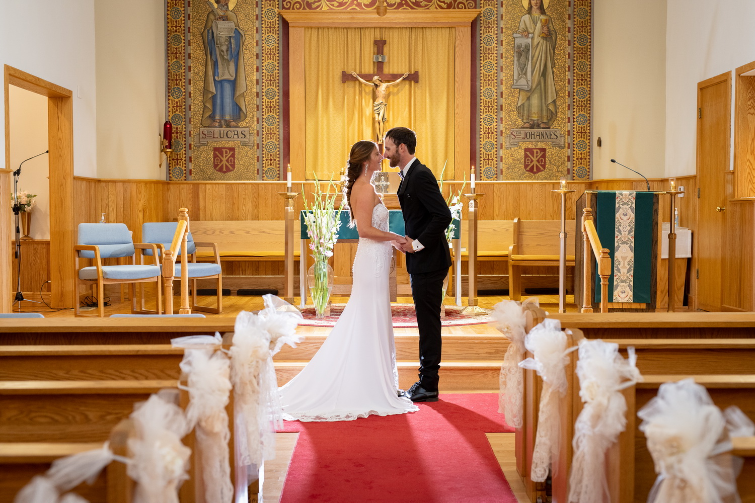 Backlit altar kiss nose to nose