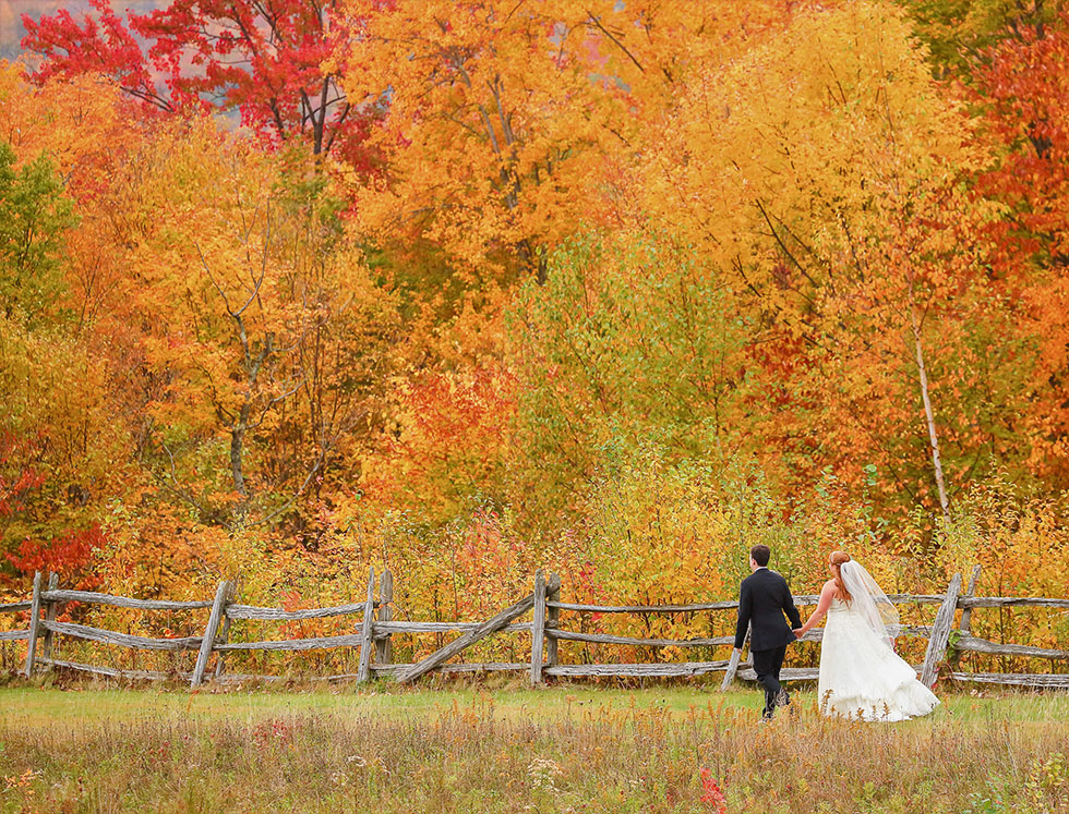 married couple in fall foliage