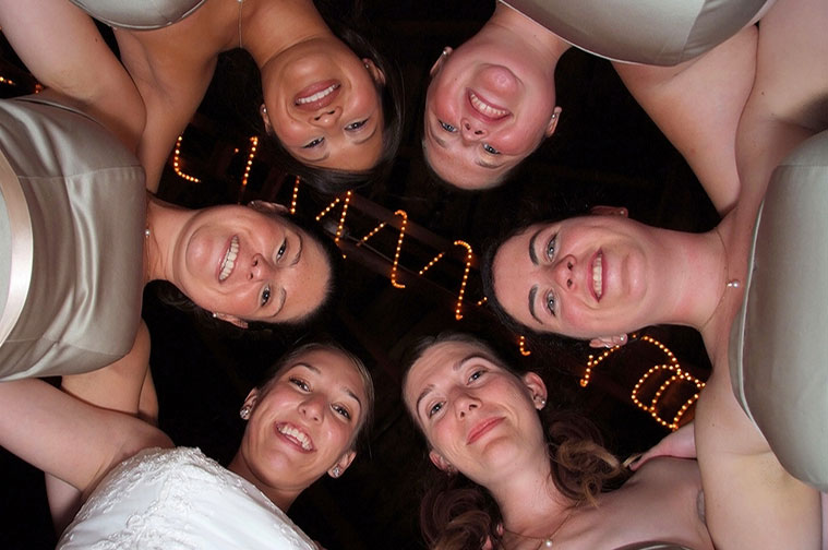 photo shooting up at smiling bridal party