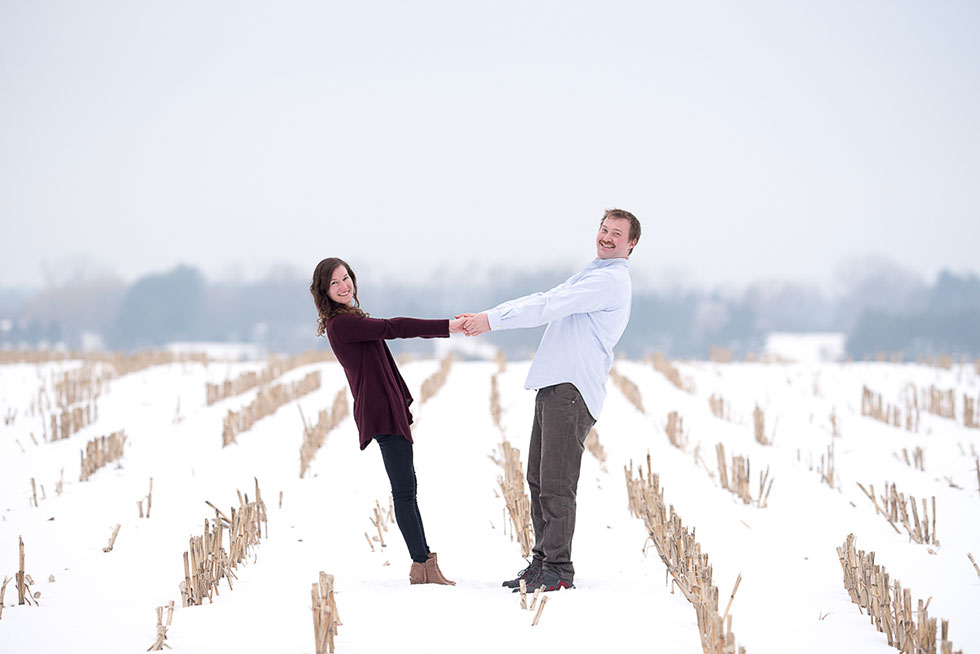 engaged couple in snowy field