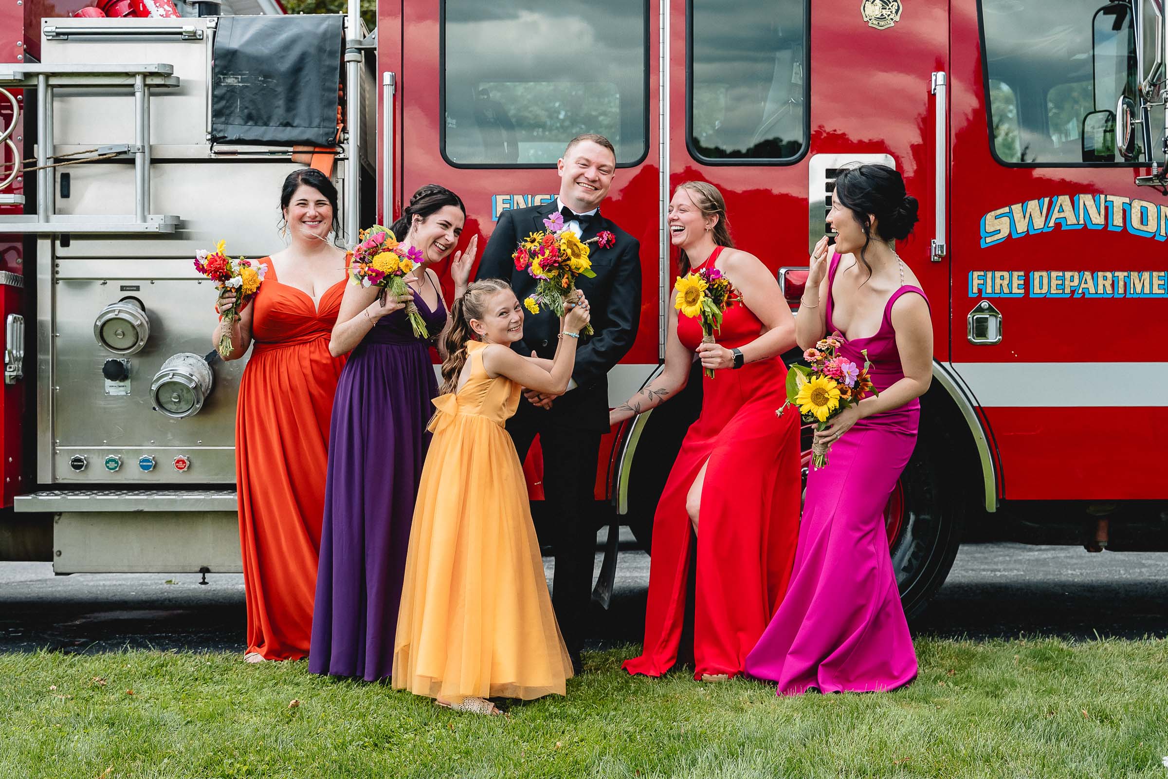 colorful wedding party with red fire truck
