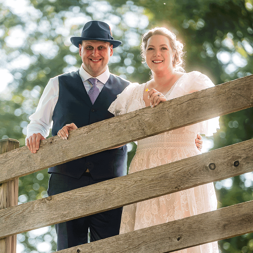Newlyweds wedding photo behind fence