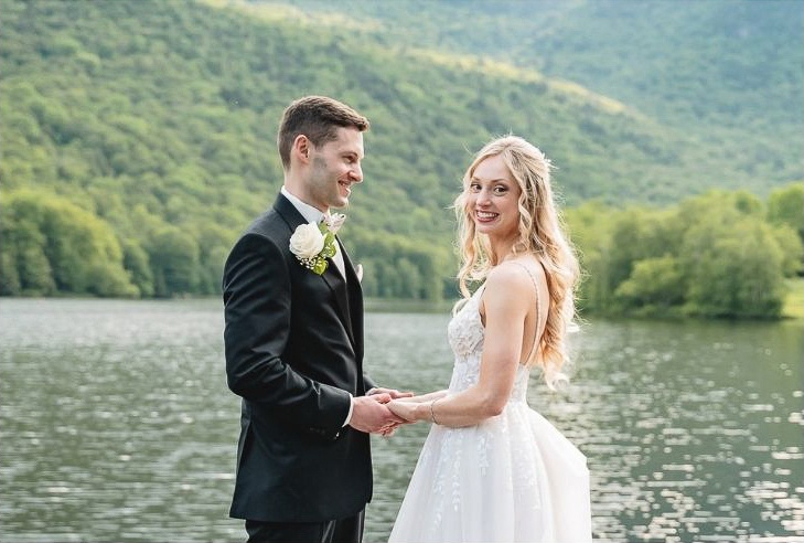 wedded couple by lake