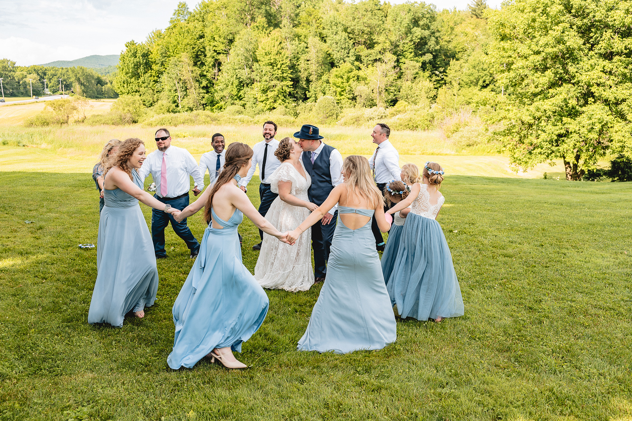 wedding party dancing round the newlyweds